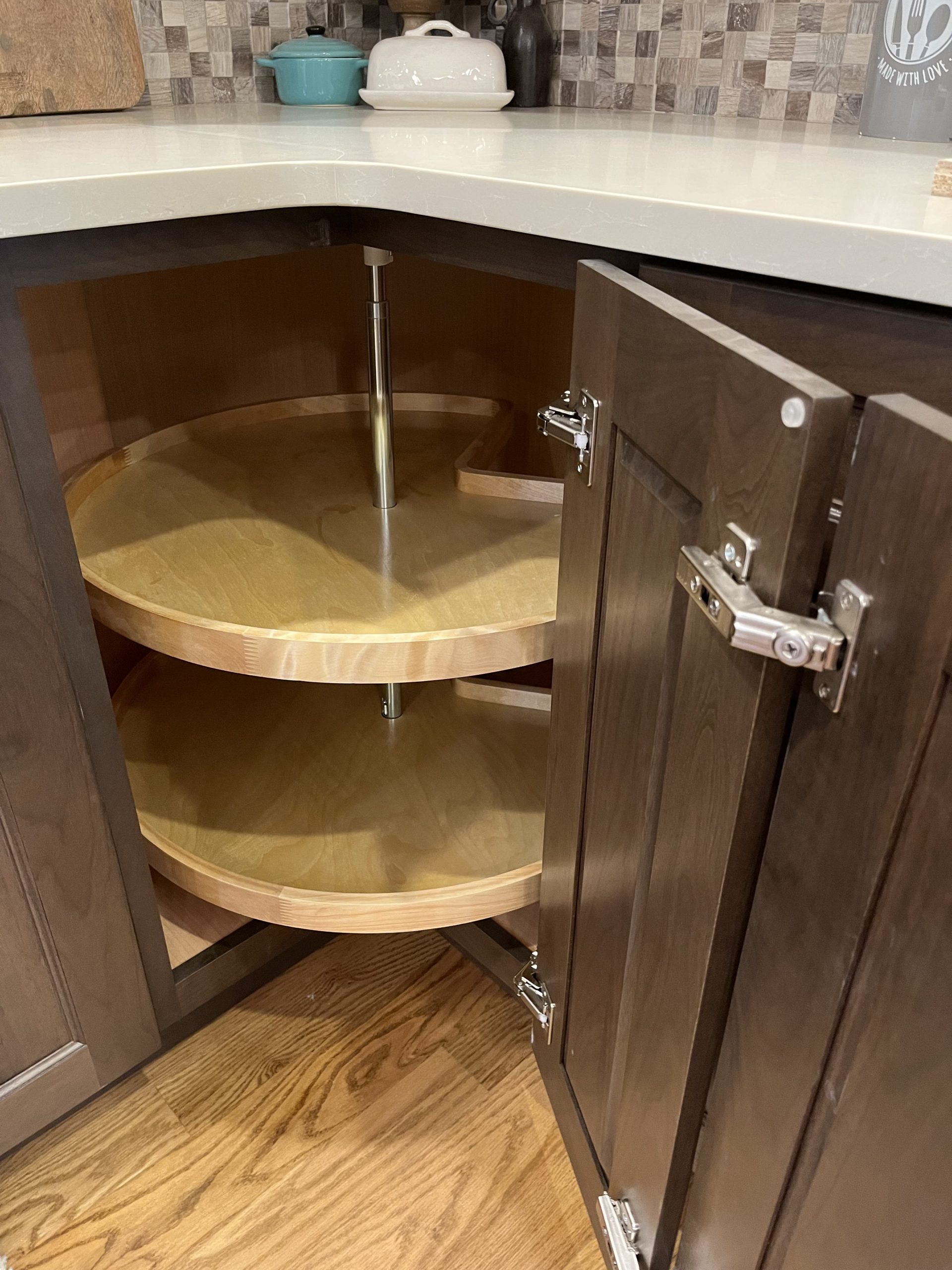A lazy susan keeps everything accessible in a corner cabinet.